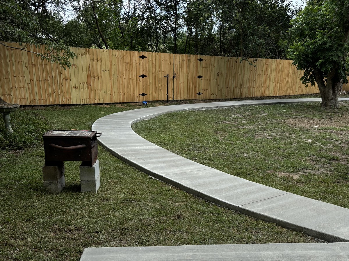Curved residential concrete walkway and patio slab poured by Willie Jackson